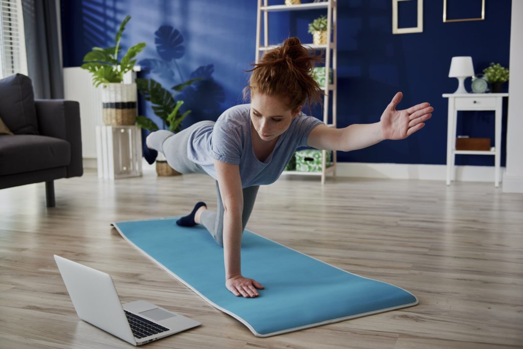 Woman taking online lesson of home workout