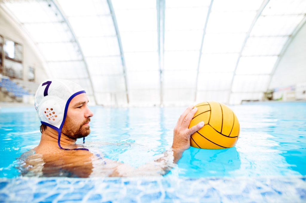 Water polo player in a swimming pool.