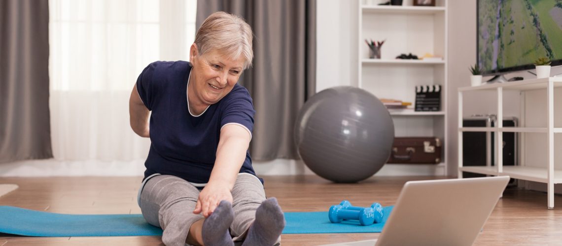Cheerful old woman doing sport