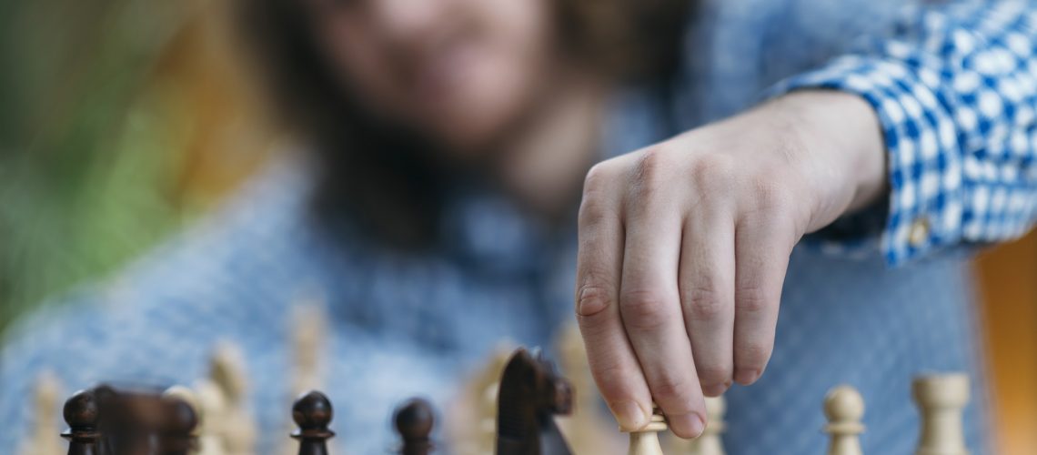 Hand of Chess Player Moving the Chess Piece