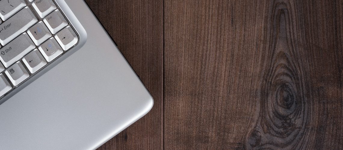 Laptop On Brown Wooden Background