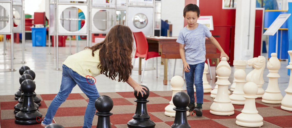 Schoolchildren playing giant chess at a science centre